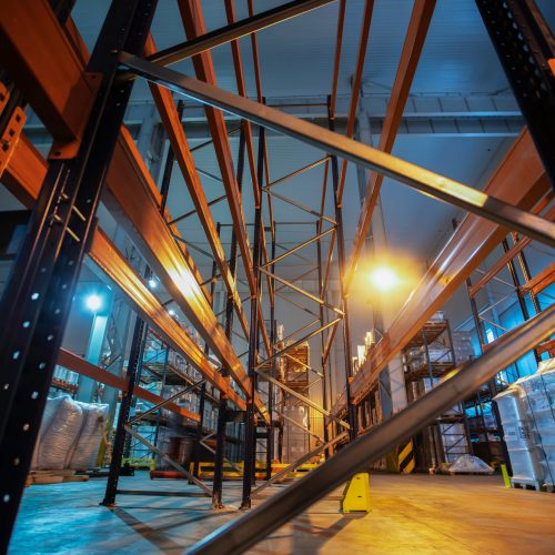 Warehouse premises of a factory or workshop with metal shelves.