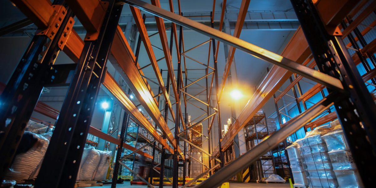 Warehouse premises of a factory or workshop with metal shelves.