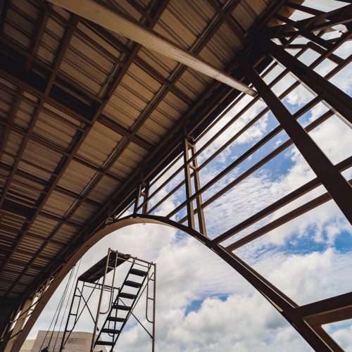 A structure featuring wooden slats on construction site contributing to its architectural style.